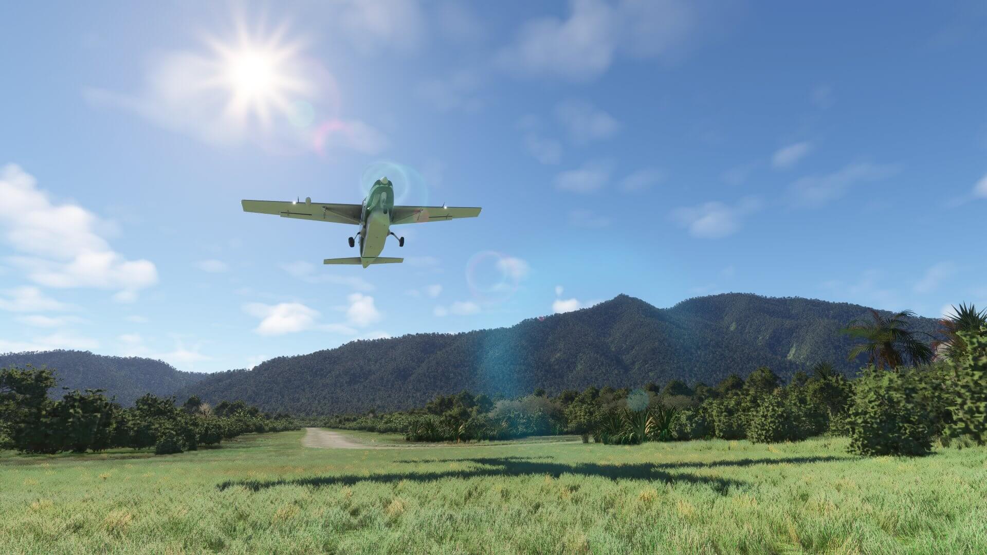 A high-wing propeller aircraft takes off from a dirt strip runway with the sun shining overheard