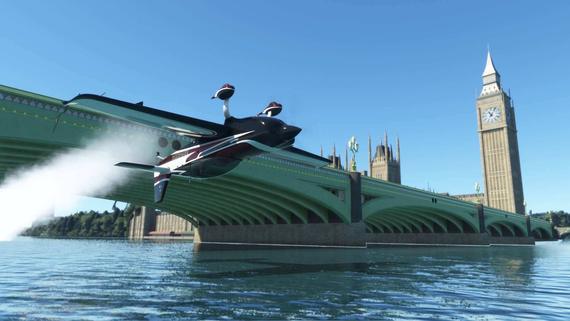 An Aerobatic aircraft with smoke trailing behind passes underneath a bridge on the River Thames, London with the Clock Tower landmark behind.