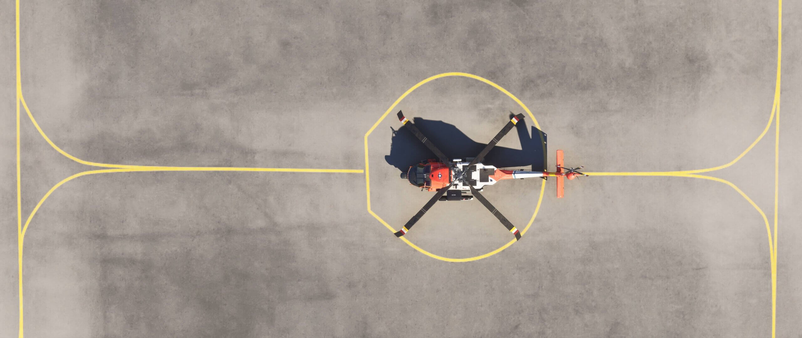 An MH60 helicopter parked on the ramp from a birds-eye view