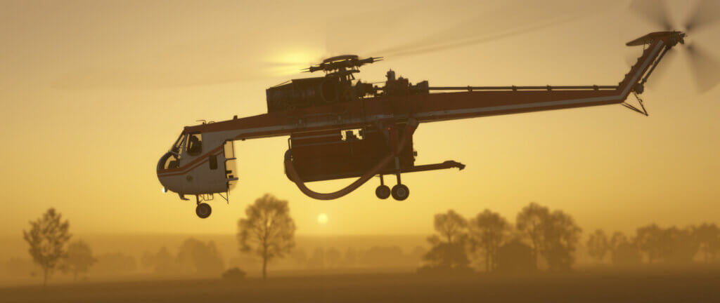 A Sikorsky helicopter cruising at low altitude during golden hour