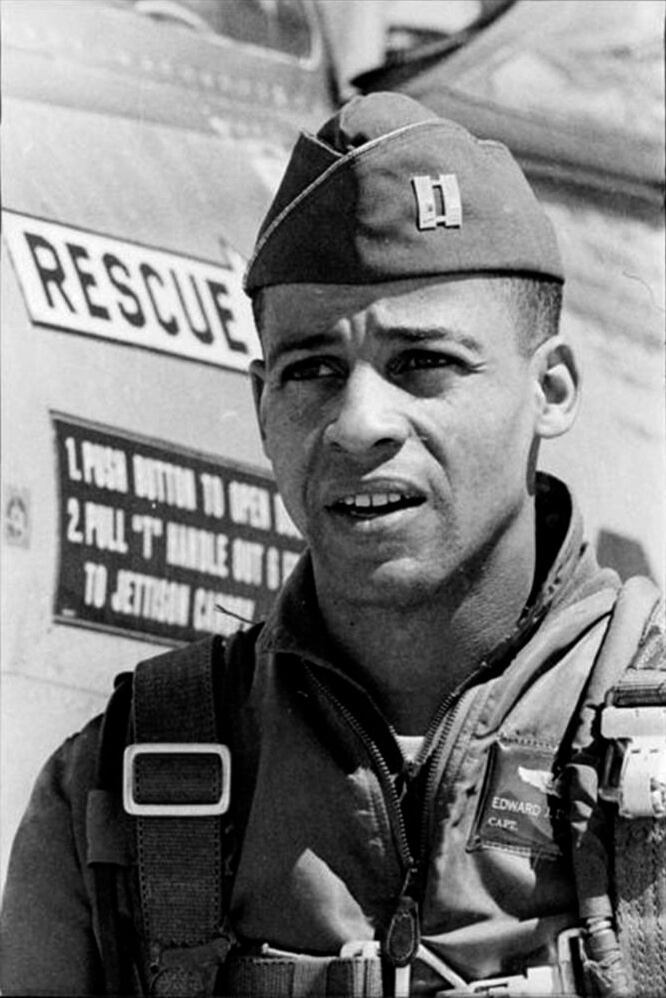 Test pilot Ed Dwight stands in front of a jet aircraft