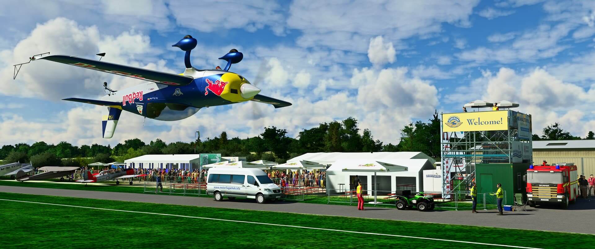 The Red Bull aerobatic aircraft flies at very low altitude and inverted whilst displaying at an air show.