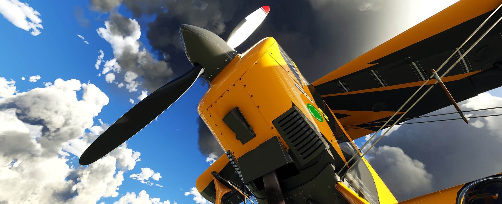 Bottom up view of the propeller and engine of a small plane.