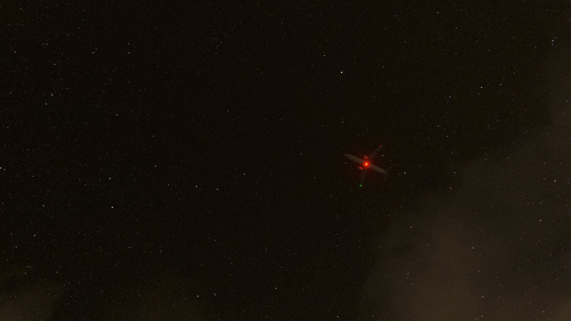 Bottom-up view of an airliner flying at night against the backdrop of a starry sky.