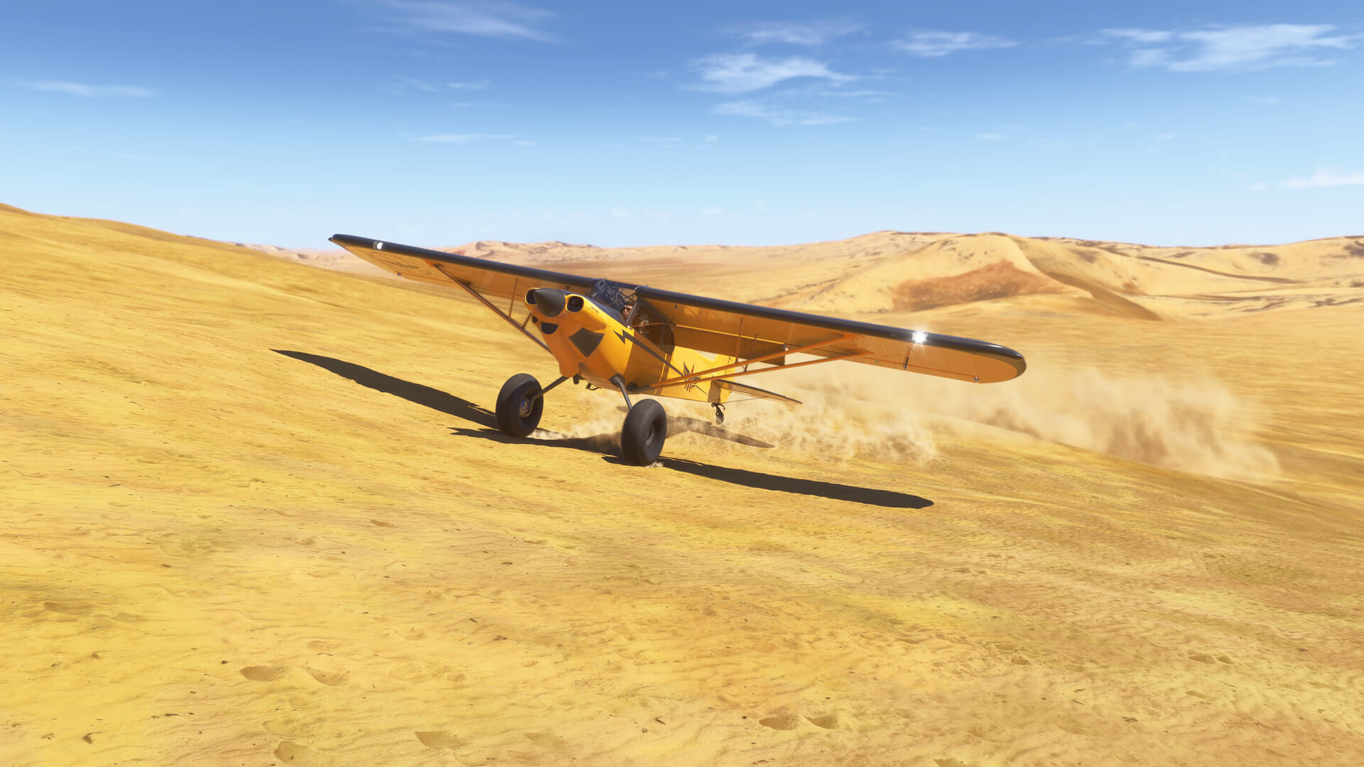 A yellow high-wing propeller aircraft touches down in the desert