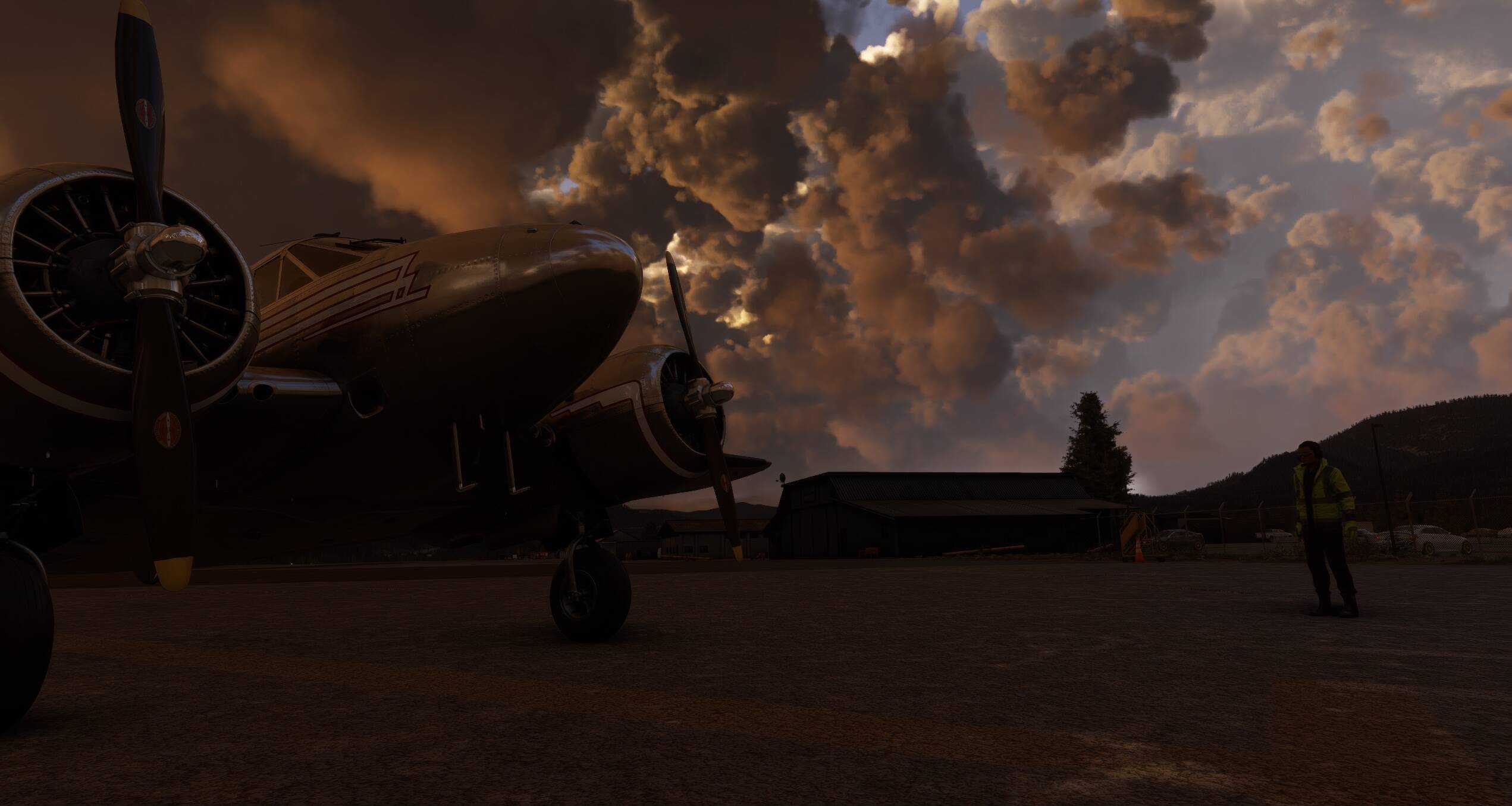 Ground crew are checking a dual engine prop aircraft on the apron of an airport, whilst thunderous clouds roll in above.