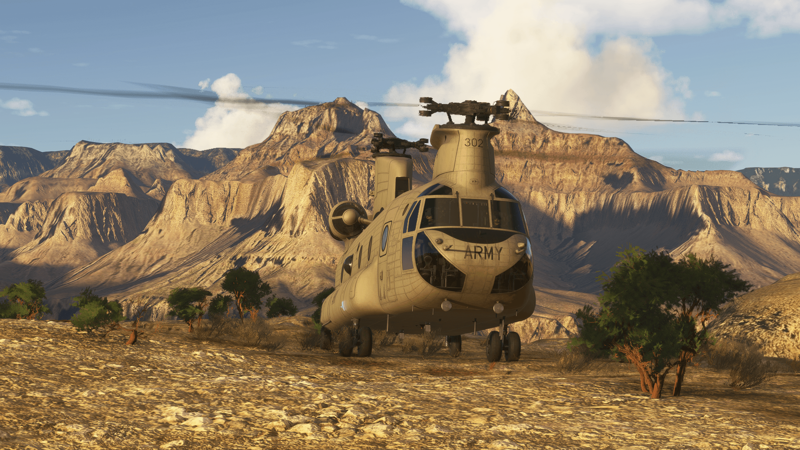A Chinook helicopter sits idle in a desert