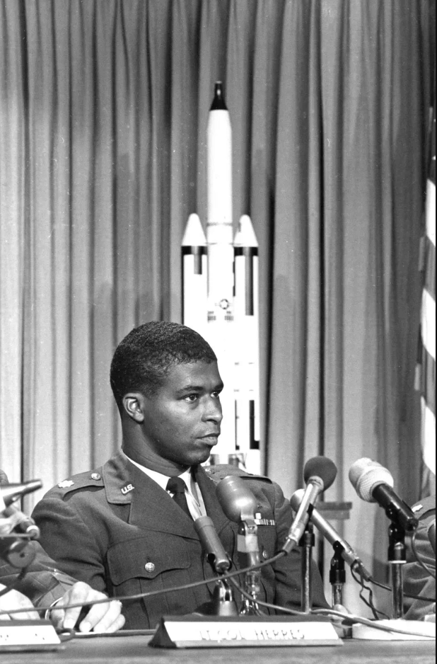 Robert Lawrence seated at a table during a press conference