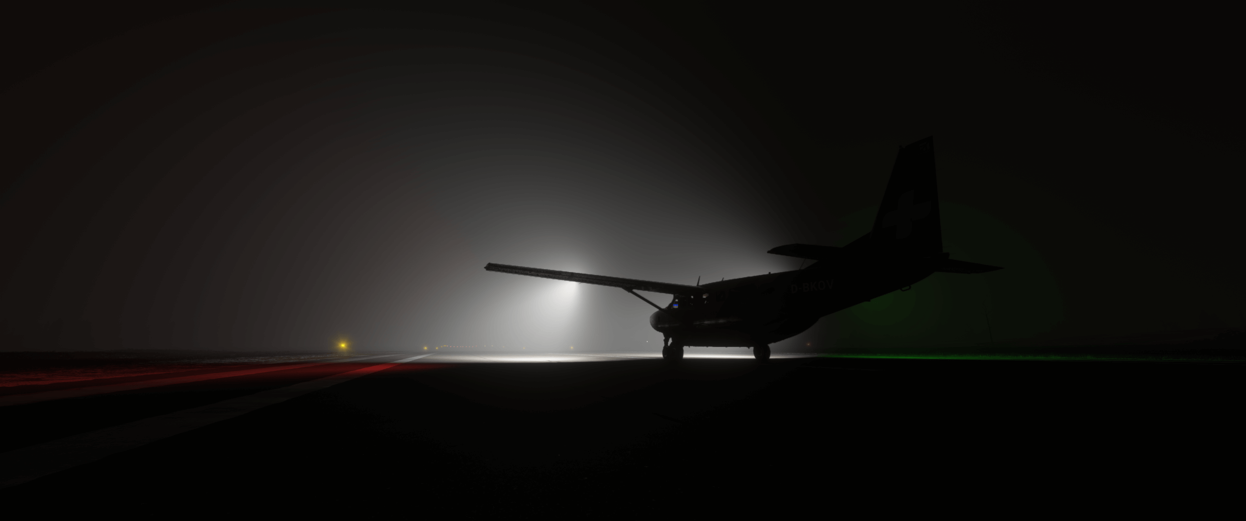 A Cessna Caravan lines up for departure with landing lights illuminating thick fog